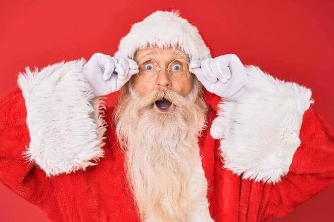 Santa is shocked holding his hat
