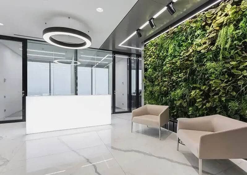 Office reception with a living wall and round light 