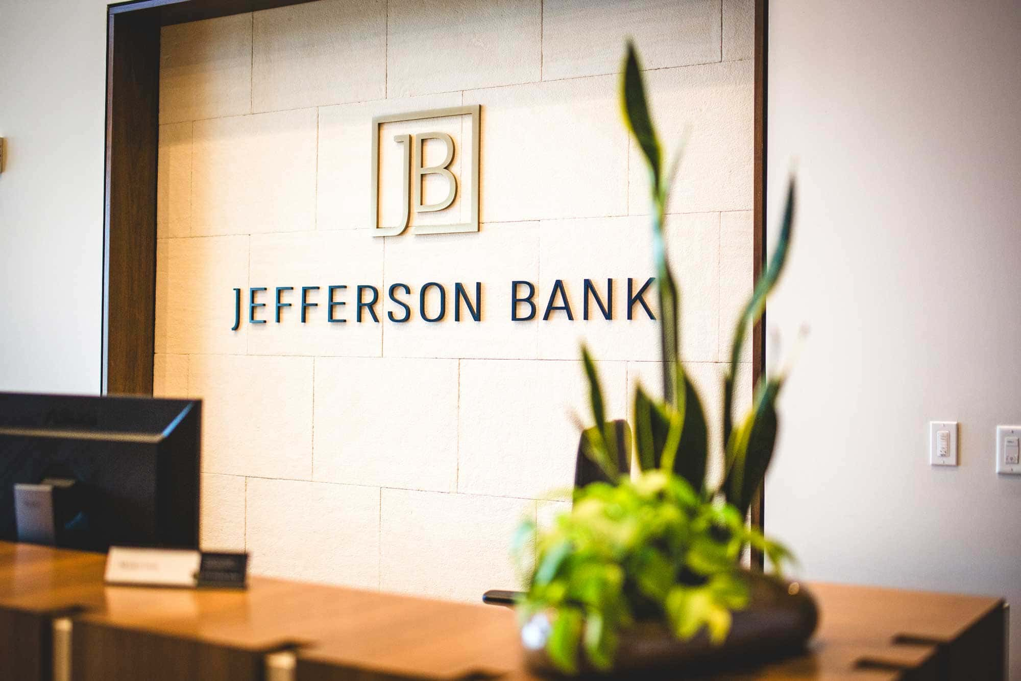 Jefferson bank logo with a plant in front 