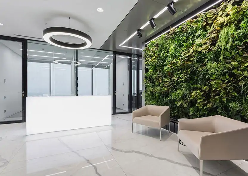 Office reception with a living wall and cream chair 